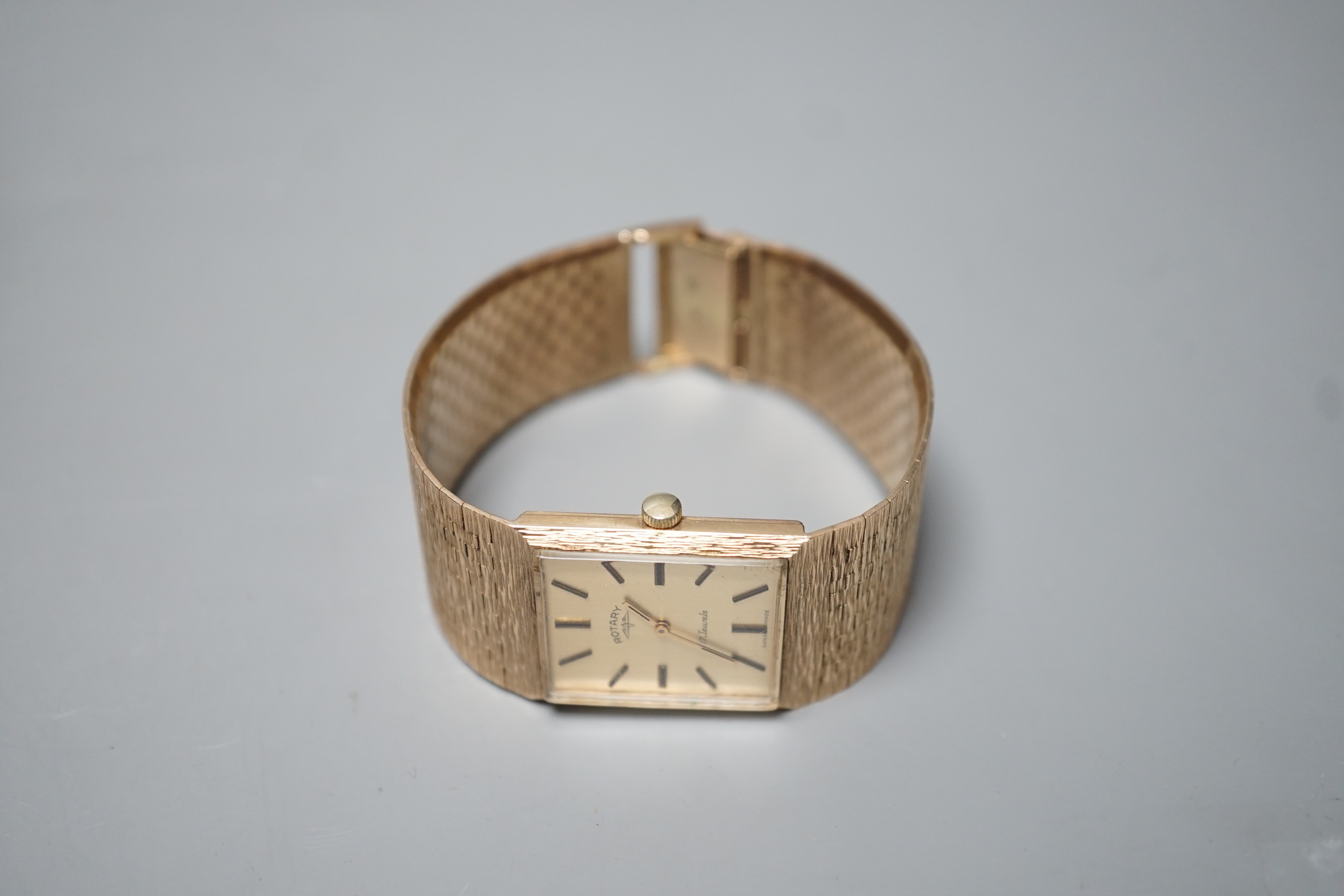 A gentleman's early 1970's textured 9ct gold Rotary manual wind dress wrist watch, with baton numerals, gross weight 67 grams, with Rotary box.